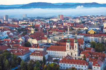 Fototapeta na wymiar Cityscape of Graz from Shlossberg hill, Graz, Styria region, Austria, in autumn, at sunrise