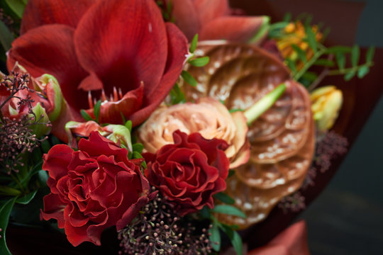 Detail closeup chic autumn bouquet in red colors in vintage style on a dark background, selective focus