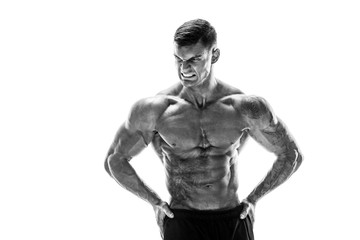 Fototapeta na wymiar Tattooed muscular super-high level handsome man posing in studio isolated on white background