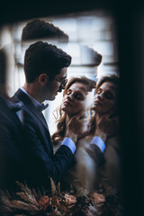 wedding photoshoot of attractive couple in Georgia: perfect appearance, stylish wedding clothes, bouquet, decor, spectacular locations of the old city of Tbilisi