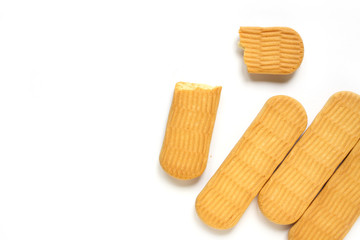 Cookies on a white background. A piece of bitten flour product isolated. Delicious dessert for a snack. Dry cracker for children, top view, copy space.