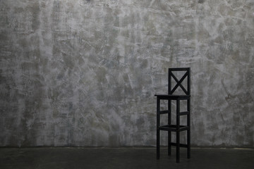 Modern lounge chair against a gray wall.