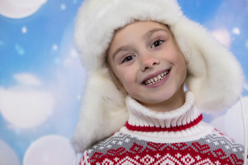 Smiling girl in the winter look. Christmas concept.