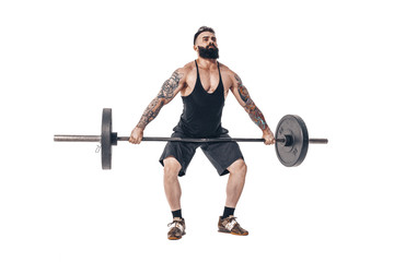 The technique of doing an exercise of deadlift with a barbell of a young muscular strong tattooed bearded sports men on a white studio background. Isolate