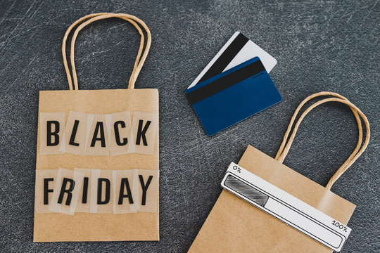 black friday shopping bag with payment cards and extra bag next to it with progress bar loading