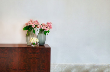 flowers in a vase on a wooden table background with copy space