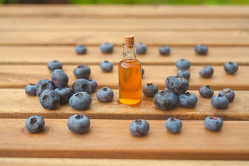 Essence of blueberry on Wooden  background in beautiful glass jar