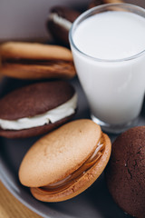 Close up Traditional chocolate and Pumpkin Whoopie pies filled made with vanilla cream cheese frosting cream