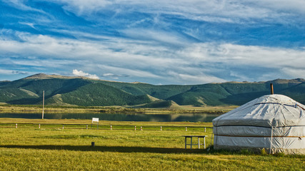 rural landscape with yurt and mountains