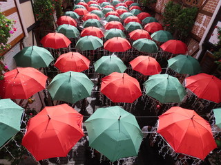 Several umbrellas seen from above. Umbrellas used as ornaments in a corridor