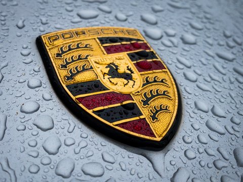 Porsche Logo Badge Crest Hood Ornament Closeup in the Rain