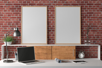 Workspace with two vertical posters mock up on the desk. Desk with drawers in interior of the studio or at home with red brick wall. Clipping path around poster. 3d illustration.