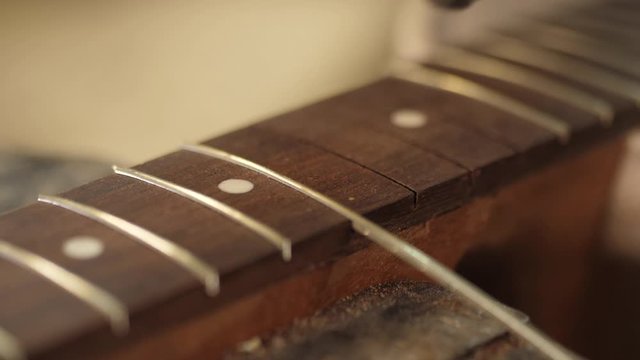 Craftsman artisan fitting in brass fret in wood guitar finger board arm 4k