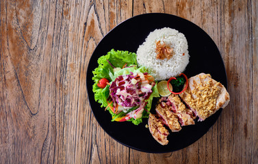 Grilled tuna steak with rice and vegetables on a wooden table. Top view. Image with place for text.