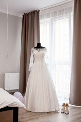Tree wedding dress on a mannequin in room