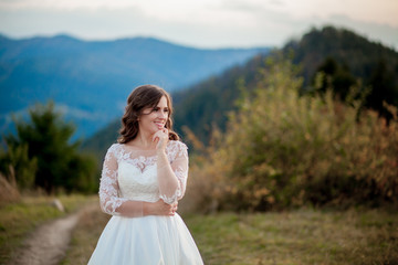 Fototapeta na wymiar Bride in the mountains. The concept of lifestyle and wedding