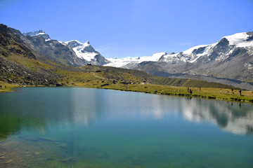 Gorgeous Lake Stellisee with the Swiss Alps and hikers, Zermatt, Switzerland