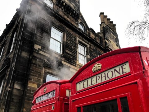 Red Telephone Call Box with Steam Rising on Edinburgh, Scotland Royal Mile