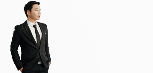 young businessman Asian wear a black suit, be a smile and standing smart poses isolated on a white background.with banner copy space