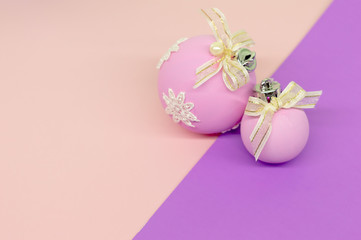 Flat lay, Christmas spheres, pink, white and purple background, Xmas and New Year holiday