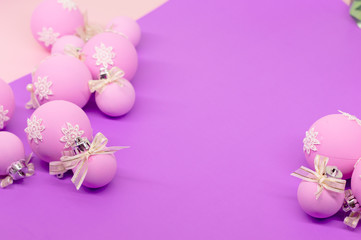 Flat lay, Christmas spheres, pink, white and purple background, Xmas and New Year holiday