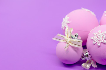 Flat lay, Christmas spheres, pink, white and purple background, Xmas and New Year holiday