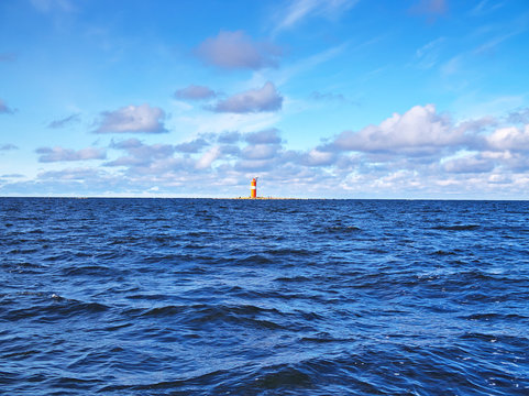 Small orange unmanned lighthouse in the Baltic Sea near Pietarsaari, Finland