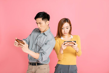 Cheerful young couple watching and playing the smart phone