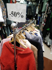 Sales of various clothes  with fifty percent discount in the boutique in the mall