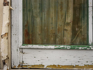 Close up image of an antique whitewashed screen door frame