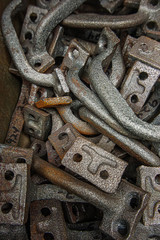 Close upof metal handles and hinges stacked in a bin