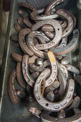 Closeup of old metal horse shoes stacked together