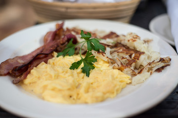 Bacon pork, scrambled eggs and roasted potatoes for brunch
