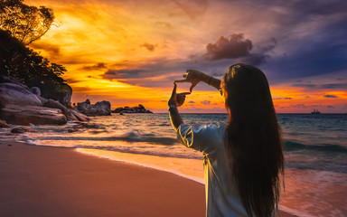 Summer lifestyle traveler woman hand doing finger frame joyful scenery sea beach landscape at...