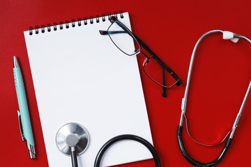 Stethoscope on a red table, concept medicine