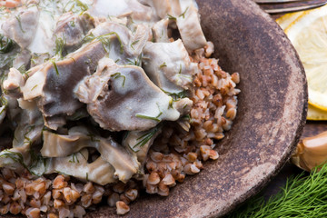Stewed turkey stomachs with vegetables and buckwheat in a bowl