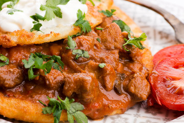 Potato pancakes with meat, vegetable, tomato and parsley