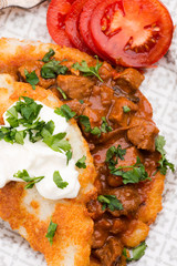 Potato pancakes with meat, vegetable, tomato and parsley