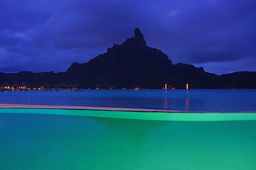 Night view of the Mont Otemanu mountain  seen from the Meridien Bora Bora resort over the lagoon in French Polynesia, South Pacific - obrazy, fototapety, plakaty