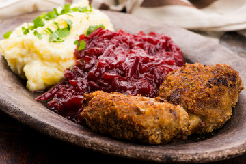 Prepared dinner on the plate. Melted meat, potatoes, beetroot