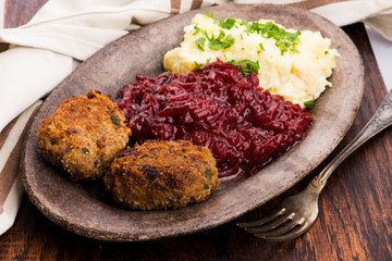 Prepared dinner on the plate. Melted meat, potatoes, beetroot