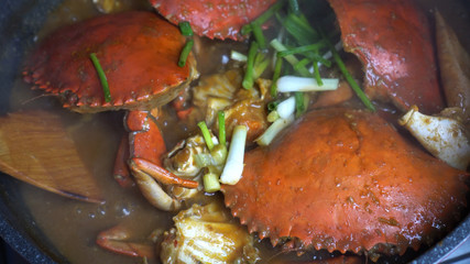 Fototapeta na wymiar Chef cooking Chili Crab Singapore Chinese cuisine iconic dish