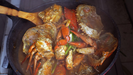 Chef cooking Chili Crab Singapore Chinese cuisine iconic dish