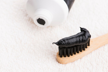 Toothbrush with black charcoal toothpaste