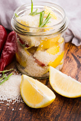Preserved Lemons with salt on a wooden board