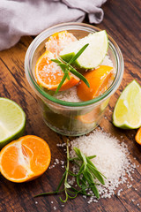 Preserved Lime and Mandarin with salt on a wooden board