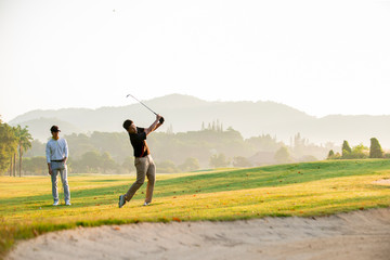  professional  golfer  hit sweeping ball on golf course