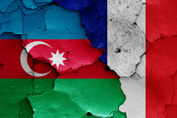 flags of Azerbaijan and France painted on cracked wall
