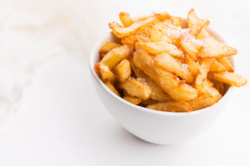 Bowl of potatoe fries on a white background