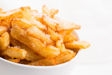 Bowl of potatoe fries on a white background